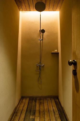 a bathroom with a shower with a light on the wall at 大山初里 Origin Villa Village Hotel&Resort in Tonglu