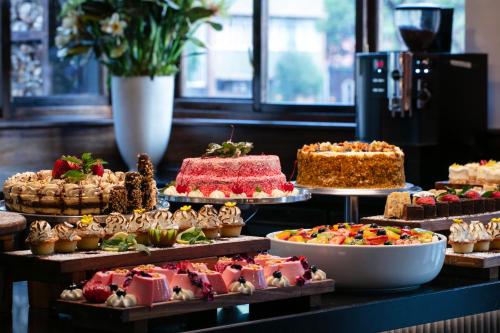a display of different types of cakes and pastries at Hotel 224 & Apartments in Pretoria