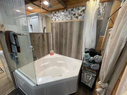 a small bathroom with a tub and a shower at Stoney Mtn High-duh-way 420&Pets yes in Gatlinburg