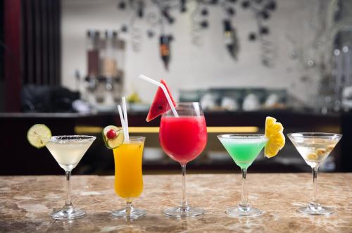 a group of four cocktails sitting on a bar at Hanoian Central Hotel & Spa in Hanoi