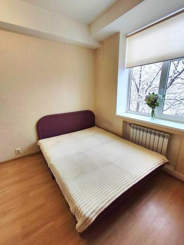 a large bed in a room with a window at New apartments in the city center, Smart TV in Kharkiv