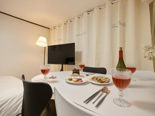 a table with a bottle of wine and wine glasses at Warm Place in Seoul