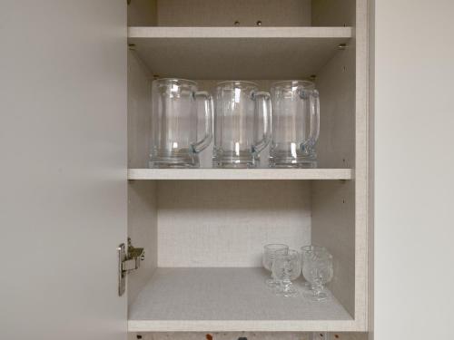 a cupboard with glasses and wine glasses on it at Warm Place in Seoul