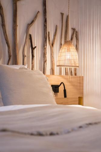a bedroom with a bed with a table with a lamp at Magazin Rooms in Salzburg
