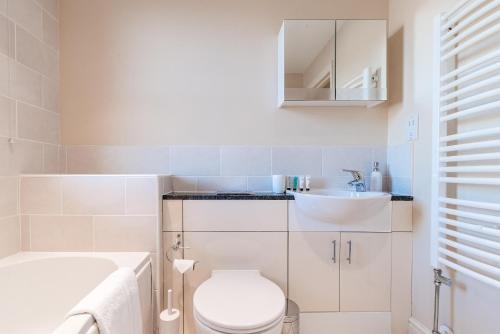 a bathroom with a white toilet and a sink at Camstay New Street in Cambridge