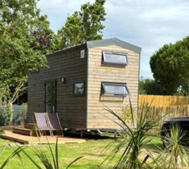 a small house sitting on top of a yard at Eco Tiny housse in La Brée-les-Bains