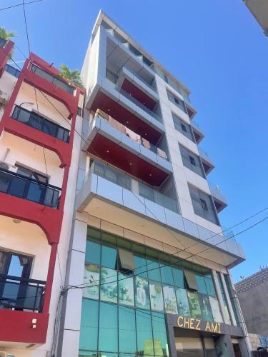 a tall apartment building with a sign on it at BB Immo APPART HOTEL in Dakar