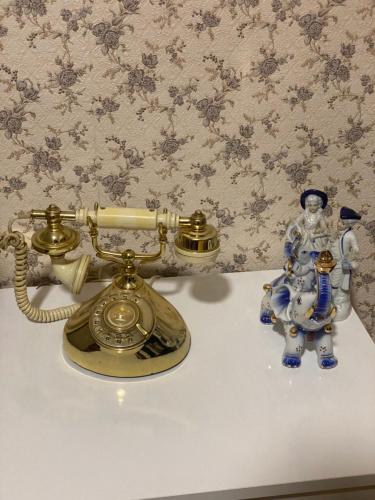 a telephone and a figurine on a table at Anna'S Home in Kutaisi
