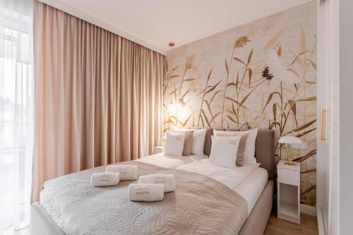 a bedroom with a bed with two towels on it at DELUXE SAND APARTMENT & SPA Posesja Plażowa by POSESJA APARTAMENTY in Grzybowo