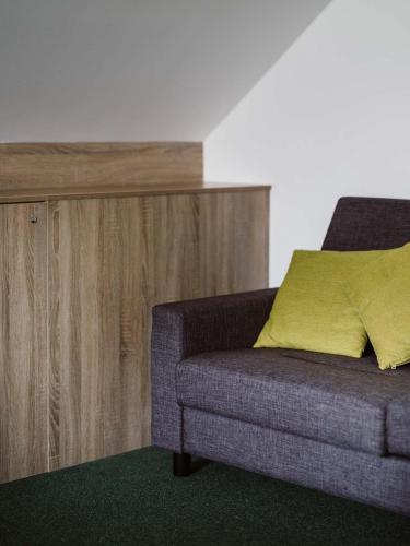 a living room with a couch and a wooden cabinet at Farma Moulisových in Nezvěstice