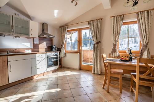 a kitchen with a table and chairs and a dining room at Pension Edelweiss in Breitenbach