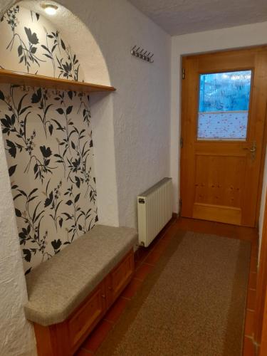 a small room with a bench and a door at Ferienwohnung Patricia in Silbertal