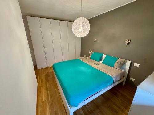 a small bedroom with a bed with blue sheets at Mountain Space Tarvisio in Tarvisio