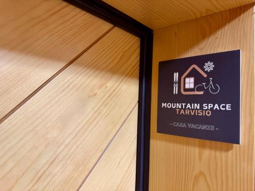 a sign on the wall of a building with a house at Mountain Space Tarvisio in Tarvisio