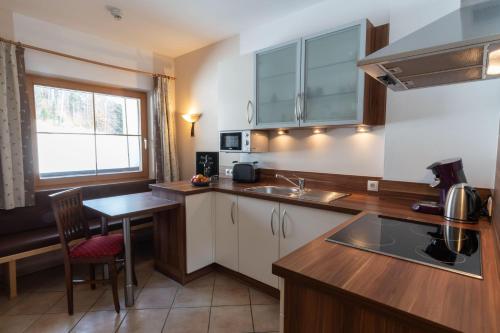 a kitchen with a sink and a counter top at Pension Edelweiss in Breitenbach