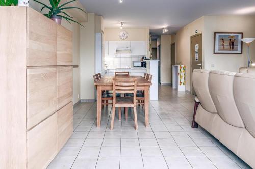 a kitchen and dining room with a table and chairs at Mathieu 1 - A2 G in Oostduinkerke