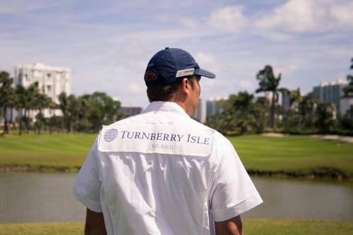 a man standing in front of a golf course at JW Marriott Miami Turnberry Resort & Spa in Aventura