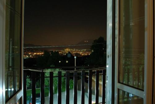 a view of a city at night from a balcony at La Casa Sull'aia,AV in Santo Stefano del Sole