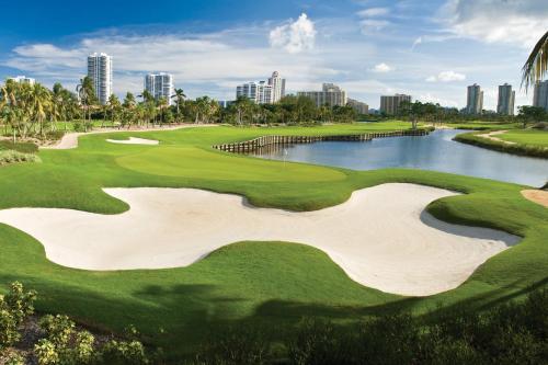 a golf course with a view of the city at JW Marriott Miami Turnberry Resort & Spa in Aventura