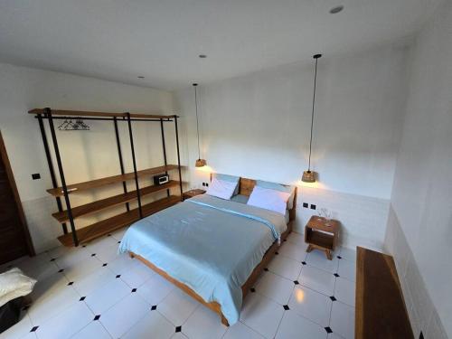 a bedroom with a bed and a tiled floor at Villa crush of heart with swimming pool in Umalas