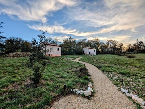 a path in the middle of a field at Aux Trois Chênes Lodges Spas in Mercuès