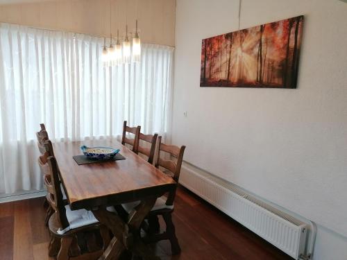 a dining room with a wooden table and chairs at Ferienhaus Berganker in Willingen in Willingen