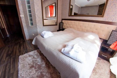 a bedroom with a bed with towels on it at Pałac Saturna in Czeladź