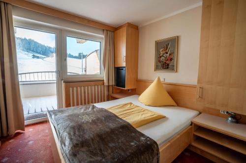 a bedroom with a bed and a large window at Pension Edelweiss in Breitenbach
