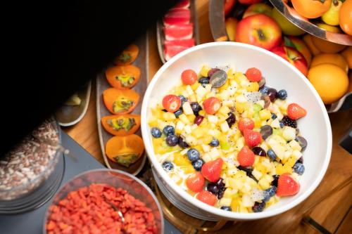a bowl filled with fruit and vegetables on a table at Ca' Bonfadini Historic Experience in Venice