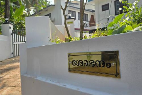 a metal plate on a white wall at Entire 4 Bedroom Villa in Kannur in Edakkād