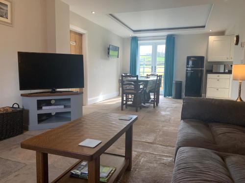 a living room with a couch and a table at White Lea in Grinton