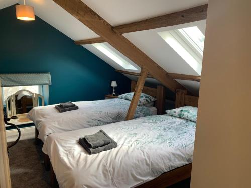 two beds in a attic room with skylights at White Lea in Grinton