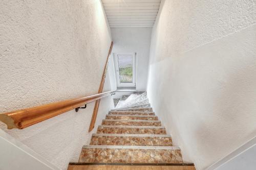 a staircase in a house with a stair case at Werrapark Resort Hotel Frankenblick in Masserberg