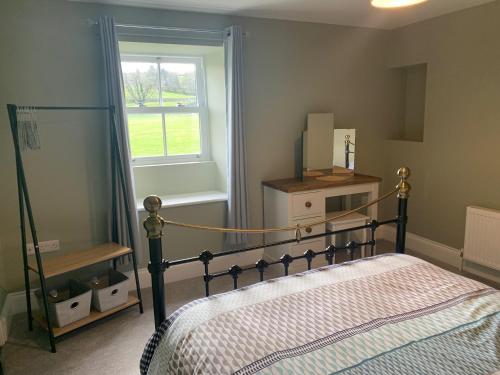 a bedroom with a bed and a window at White Lea in Grinton