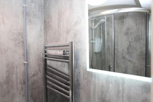 a bathroom with a shower and a mirror at Abbey Foregate in Shrewsbury
