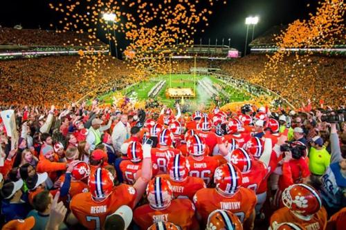 a group of football players standing in front of a crowd at ClemsonILakesideIParkPassIPizzaOvenlYouTubeTVlFirePit in Anderson