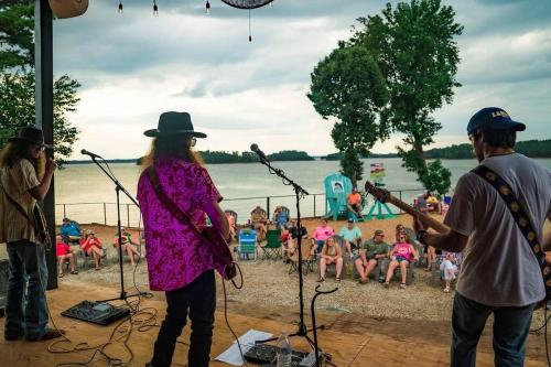 a group of people playing music on the beach at ClemsonILakesideIParkPassIPizzaOvenlYouTubeTVlFirePit in Anderson