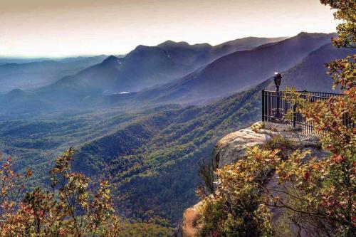 a person standing on the edge of a mountain overlooking a valley at ClemsonILakesideIParkPassIPizzaOvenlYouTubeTVlFirePit in Anderson