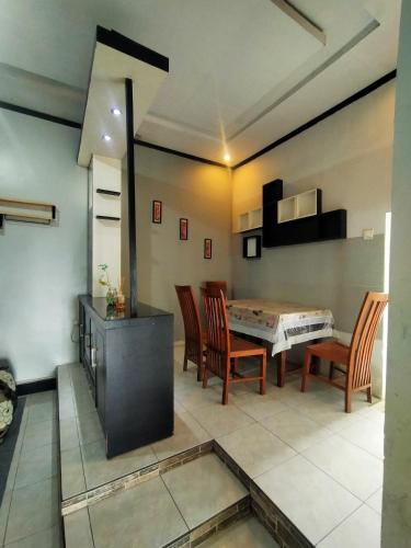 a kitchen and dining room with a table and chairs at Pandya Bromo Villa in Pasuruan