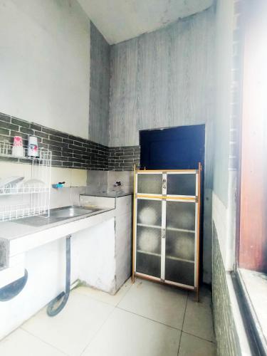 a kitchen with a sink and a shelf in it at Pandya Bromo Villa in Pasuruan