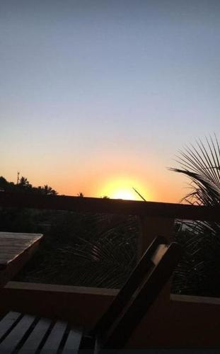 a sunset with the sun setting in the background at Village Lagoinha Ceará in Tigre