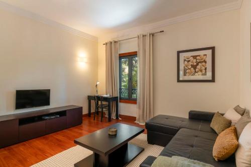 a living room with a couch and a table at Arriaga Residence I by An Island Apart in Funchal