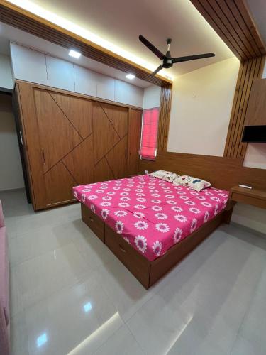 a bedroom with a bed with pink sheets and a fan at 3 BHK exclusive suite in Nashik