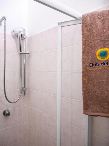 a bathroom with a shower and a towel on a wall at Club del Sole Stork Family Collection in Giulianova