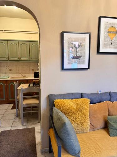 a living room with a blue couch and a table at Pandoras House Arachova in Arachova