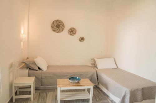 a small room with two beds and a table at Christiana Hotel in Ambelas