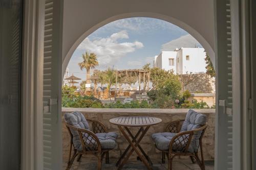 a patio with a table and chairs and a view of a city at Christiana Hotel in Ambelas