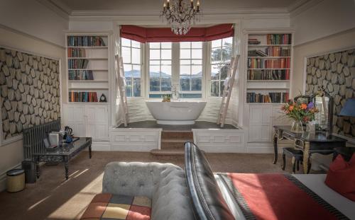 a living room with a bath tub in a window at Château Rhianfa in Menai Bridge