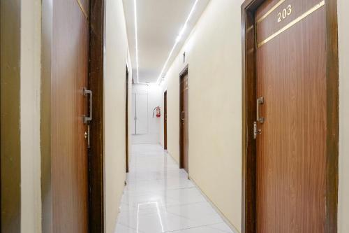 a corridor of a hospital with two doors at FabExpress Powai Inn in Mumbai