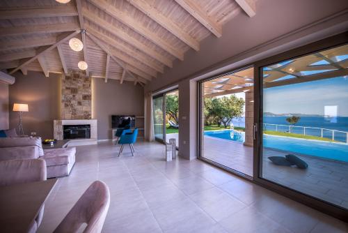 a living room with a view of the ocean at Avra Luxury Villa & Spa in Keri